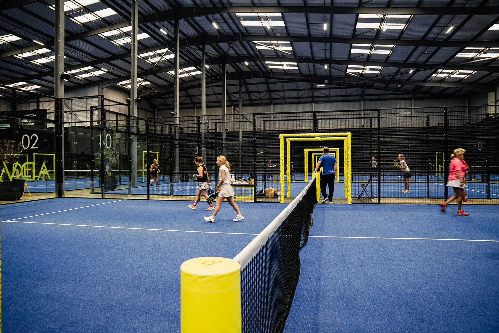 A wide view across the indoor padel courts